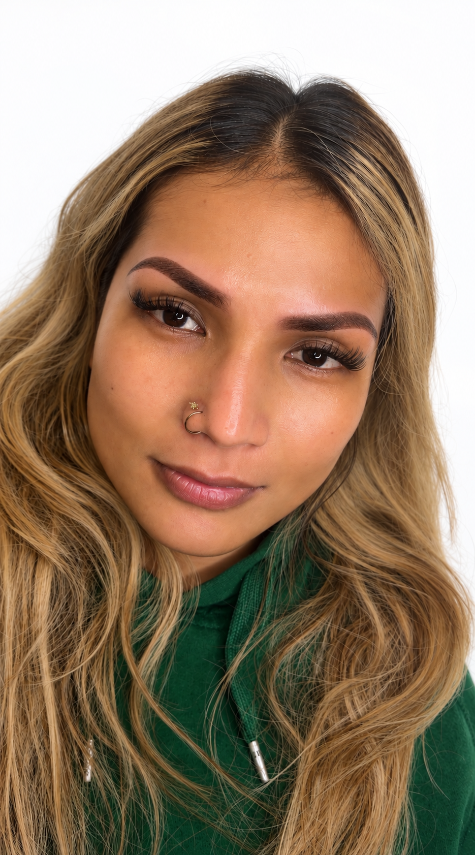 Client with fresh powder brows, lash extensions and lip blush after a Natalia Beauty appointment